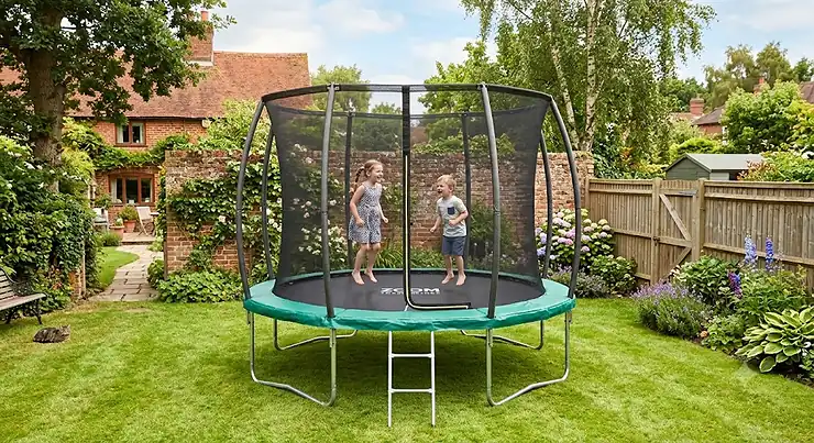 A 12ft trampoline with enclosure set up in a typical British back garden on a sunny day.
