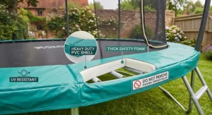 View of the thick spring cover pad on a 12ft trampoline with enclosure, showing safety features.