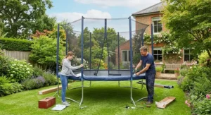 Parent assembling a 14ft trampoline in a back garden during a sunny weekend