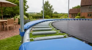 Detail shot of the galvanised steel springs on a 16ft trampoline, highlighting bounce quality and durability.