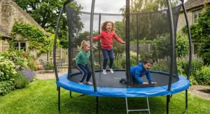 Happy children playing safely on a 12ft trampoline in a back garden