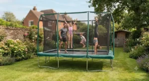 A family enjoying safe garden exercise and bouncing on a large rectangular trampoline for gymnastics practice
