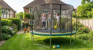 Happy children bouncing safely on an oval trampoline in a sunny garden