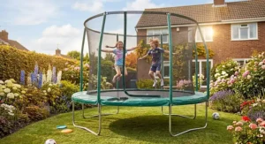 Energetic children jumping on a large garden trampoline during the summer holidays.