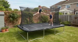 A large rectangular trampoline installed in a back garden for children practicing gymnastics routines