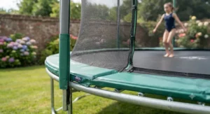 Close-up view of safety padding and enclosure net on a heavy-duty rectangular trampoline for gymnastics
