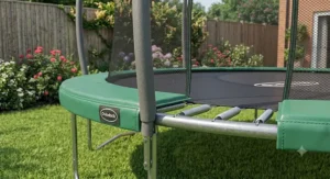 Detailed view of the safety padding and enclosure poles on a 12ft family trampoline designed for garden use.