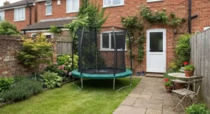 A compact round trampoline fitting neatly into a small British patio and lawn garden layout
