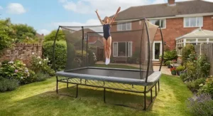 Teenage gymnast practicing high-performance jumps on a large rectangular garden trampoline